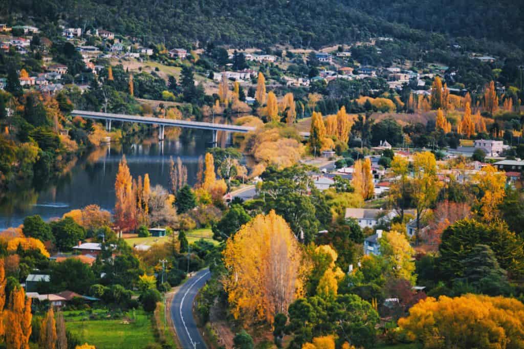 Tasmania, Australia in autumn from high angle view river, tree and bridge