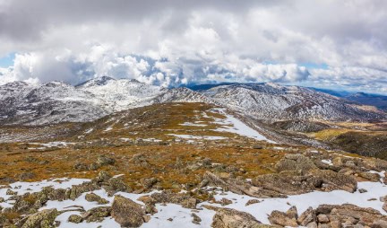 Beautiful landscape of snow-covered mountains and fluffy clouds at Mount Kosciuszko National Park Australia